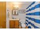 Cozy bathroom featuring a vanity with a mirror and a shower with a blue striped curtain at 6138 Bartley Ct, Indianapolis, IN 46236