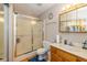Bathroom features a glass enclosed shower, toilet, and oak vanity at 6138 Bartley Ct, Indianapolis, IN 46236