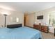 Bright bedroom featuring a blue comforter, dresser and wall mounted TV at 6138 Bartley Ct, Indianapolis, IN 46236