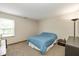 Cozy bedroom with carpeted floors, neutral walls, and a window providing natural light at 6138 Bartley Ct, Indianapolis, IN 46236
