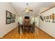 Dining room with hardwood floors, a ceiling fan, and direct access to the cozy fireplace at 6138 Bartley Ct, Indianapolis, IN 46236