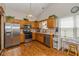 Well-equipped kitchen features stainless steel appliances, wood cabinets, and tile backsplash at 6138 Bartley Ct, Indianapolis, IN 46236