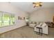 Spacious carpeted living room features large windows with great natural light and comfortable neutral-colored sofa at 6138 Bartley Ct, Indianapolis, IN 46236