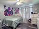 Cozy bedroom featuring stylish decor, ceiling fan, and wood plank floors at 6155 W Bayfront, McCordsville, IN 46055