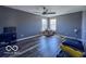 Bright bedroom with wood floors, ceiling fan, natural light and blue painted walls at 6155 W Bayfront, McCordsville, IN 46055