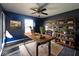 Cozy home office with hardwood floors, custom shelving, and a comfortable workspace at 6155 W Bayfront, McCordsville, IN 46055