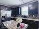 Well-lit kitchen features granite countertops, stainless steel appliances, and dark wood cabinets at 6155 W Bayfront, McCordsville, IN 46055
