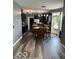 Open kitchen and dining area featuring dark cabinets and stainless steel appliances at 6155 W Bayfront, McCordsville, IN 46055