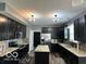 Updated kitchen with dark cabinets, stainless steel appliances, and granite countertops at 6155 W Bayfront, McCordsville, IN 46055