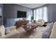 Bright living room with modern furniture, large windows, and a stylish entertainment center at 6155 W Bayfront, McCordsville, IN 46055