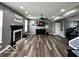 Spacious living room with fireplace, modern ceiling fan, and grey-toned walls at 6155 W Bayfront, McCordsville, IN 46055