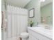 Bathroom with white vanity, decorative mirror, and a shower with a white curtain at 6460 Wasco Dr, Whitestown, IN 46075