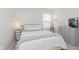 Bright bedroom featuring neutral tones, natural light, and minimalist decor with gray dresser and white linens at 6460 Wasco Dr, Whitestown, IN 46075