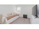 Bright bedroom featuring neutral tones, natural light, and minimalist decor with gray nightstand and television at 6460 Wasco Dr, Whitestown, IN 46075
