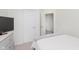 This bedroom with neutral tones, features a gray dresser and doorway leading to other rooms at 6460 Wasco Dr, Whitestown, IN 46075