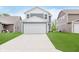 Two-story home with blue siding, white trim, and a two-car garage, complemented by a well-manicured lawn at 6460 Wasco Dr, Whitestown, IN 46075