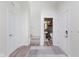 Bright foyer with luxury vinyl plank flooring, white walls, closet space, and half bath access at 6460 Wasco Dr, Whitestown, IN 46075