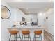 Bright kitchen featuring stainless steel appliances, granite countertops, three barstools and luxury vinyl plank flooring at 6460 Wasco Dr, Whitestown, IN 46075