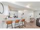 Bright kitchen features modern white cabinets, stainless steel appliances, and breakfast bar with seating for three at 6460 Wasco Dr, Whitestown, IN 46075