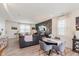 Open-concept living area with modern decor, a comfortable gray sofa, and a dining table at 6460 Wasco Dr, Whitestown, IN 46075
