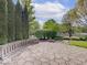 Beautiful backyard featuring a stone patio, built-in seating, and lush landscaping, creating a serene outdoor oasis at 6648 Westminster Dr, Zionsville, IN 46077