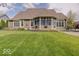 Expansive backyard features a lush lawn, complemented by the home's exterior and a screened-in porch at 6648 Westminster Dr, Zionsville, IN 46077