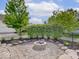 Backyard features a stone fire pit surrounded by lush landscaping, perfect for outdoor gatherings and relaxation at 6648 Westminster Dr, Zionsville, IN 46077