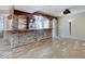 Basement bar with stainless steel appliances and stone accents at 6648 Westminster Dr, Zionsville, IN 46077