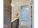 Bathroom with dark cabinets and a glimpse into an adjoining blue-walled room at 6648 Westminster Dr, Zionsville, IN 46077
