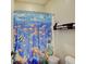 Bathroom featuring an ocean themed shower curtain and essential storage shelves at 6648 Westminster Dr, Zionsville, IN 46077