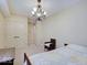 Cozy bedroom with a decorative chandelier, closet and neutral color palette for a soothing and inviting atmosphere at 6648 Westminster Dr, Zionsville, IN 46077