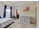 Bright bedroom featuring a tray ceiling, dresser, and charming nautical artwork at 6648 Westminster Dr, Zionsville, IN 46077