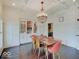 Bright dining room with decorative chandelier, paneled walls, and built-in display cabinet at 6648 Westminster Dr, Zionsville, IN 46077
