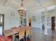Bright dining room features a decorative chandelier, wood floors, and white pillars at 6648 Westminster Dr, Zionsville, IN 46077