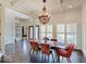 Elegant dining room features a coffered ceiling, decorative chandelier, and large windows at 6648 Westminster Dr, Zionsville, IN 46077
