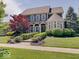 Attractive two-story home boasts manicured landscaping, stone accents, and inviting curb appeal at 6648 Westminster Dr, Zionsville, IN 46077