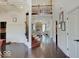 Elegant foyer features hardwood floors, a staircase, and a view into a living space with stone fireplace at 6648 Westminster Dr, Zionsville, IN 46077