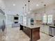 Spacious kitchen with granite countertops, stainless steel appliances, and large center island at 6648 Westminster Dr, Zionsville, IN 46077