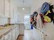 Functional laundry room with cabinets, sink, washer, and ample storage space and bright lighting at 6648 Westminster Dr, Zionsville, IN 46077