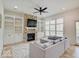 Cozy living room features a stone fireplace, built-in cabinets, and large windows for natural light at 6648 Westminster Dr, Zionsville, IN 46077