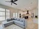 Spacious living room with a ceiling fan and an open view to the kitchen and a comfortable grey couch at 6648 Westminster Dr, Zionsville, IN 46077