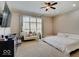 Comfortable main bedroom with a large bed, chaise lounge, and natural light streaming through the window at 6648 Westminster Dr, Zionsville, IN 46077