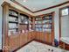 Spacious office with custom built-ins, wood flooring, and ample storage space, bathed in natural light at 6648 Westminster Dr, Zionsville, IN 46077