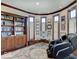 Comfortable office with built-in bookshelves, wood trim, and natural light, featuring a massage chair at 6648 Westminster Dr, Zionsville, IN 46077
