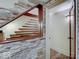 Unique staircase design featuring a stone wall and wooden banister, adding architectural interest at 6648 Westminster Dr, Zionsville, IN 46077