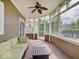 Charming sunroom with large windows, comfortable seating, and ceiling fan, perfect for relaxing and enjoying the view at 6648 Westminster Dr, Zionsville, IN 46077