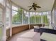 Inviting sunroom with large windows, comfortable seating, and a ceiling fan, creating a cozy indoor-outdoor living space at 6648 Westminster Dr, Zionsville, IN 46077