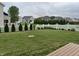 Wide view of the backyard featuring a well kept lawn and a white picket fence at 6836 Eagle Crossing Blvd, Brownsburg, IN 46112