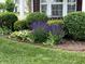 Landscaped garden bed with various flowering plants and rounded shrubs at 6836 Eagle Crossing Blvd, Brownsburg, IN 46112