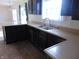 Open kitchen features dark cabinetry, double sink and countertop space at 6836 Eagle Crossing Blvd, Brownsburg, IN 46112
